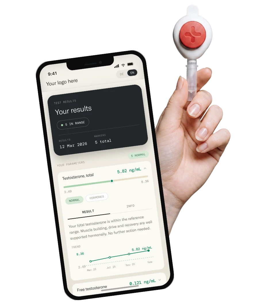 A hand holding the Remi Health fingerprick collector beside the customer portal on a phone